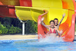children sliding down a water slide