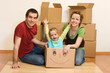 Happy family in their new home sitting on the floor