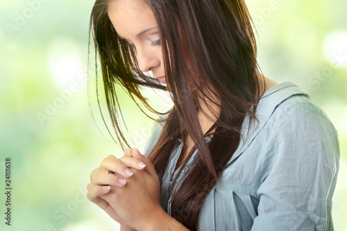 Photo: Young caucasian woman praying Young caucasian woman praying