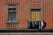 Clothes hanging outside a window to dry.