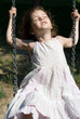 Happy little girl swinging