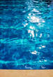 Detail of a swimming pool blue water in summer time