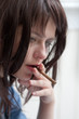 Depressed brunette girl with cigar