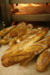 bringing bread loaves out of the oven