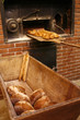 bringing bread loaves out of the oven