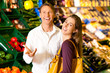 People in supermarket shopping groceries