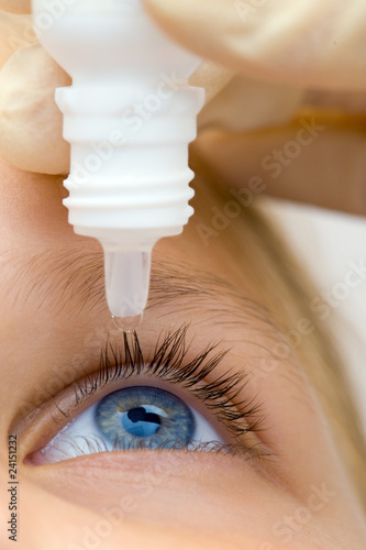 Photo: Oculist applying pipette for patients Oculist applying pipette for patients
