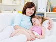 Mother with sleeping daughter at home