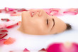 Photo: Attractive girl takes a bath with milk and rose petals Attractive girl takes a bath with milk and rose petals