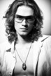 BW portrait of long-haired handsome man in sunglasses