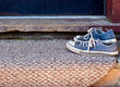Blue Tennis Shoes on Welcome Mat Blue Tennis Shoes on Welcome Mat