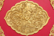 Double golden dragon in chinese style. On red wood.