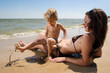 Young mother with her little son at the beach