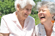 Two elderly women laugh, outdoors Two elderly women laugh, outdoors