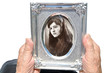 In youth. Mature woman holding old photograph In youth. Mature woman holding old photograph