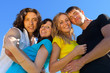 Young people, two girls and two boys, hugged each other