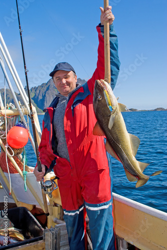 Foto: Fisherman with big fish and the spinning Fisherman with big fish and the spinning