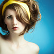 Portrait of the young woman on blue background