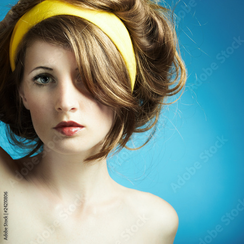 Photo: Portrait of the young woman on blue background Portrait of the young woman on blue background
