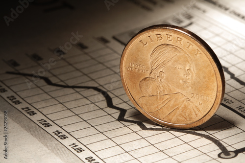 Photo: dollar on newspaper chart dollar on newspaper chart