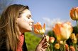 A young woman smelling a tulip, close-up