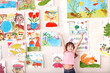 Child in art class with picture.