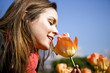 A young woman smelling a tulip, close-up