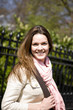 Portrait of a young woman smiling, outdoors