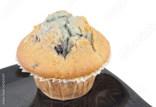Photo: close in view of blueberry muffin on white background close in view of blueberry muffin on white background
