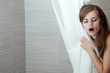 gorgeous woman behind curtain singing at modern bathroom