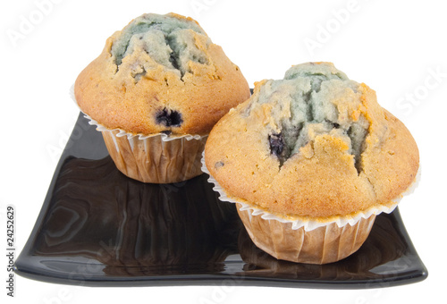 Photo: two blueberry muffins on plate isolated on white two blueberry muffins on plate isolated on white