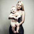 Beautiful young mom with naked baby