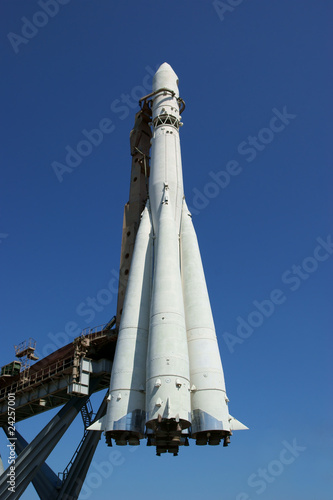 Photo: Space rocket on blue sky background Space rocket on blue sky background