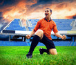 Happiness football player after goal on the field of stadium und