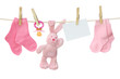Pink baby goods and blank note hanging on the clothesline Pink baby goods and blank note hanging on the clothesline