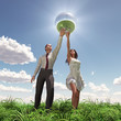 man and woman holding globe man and woman holding globe