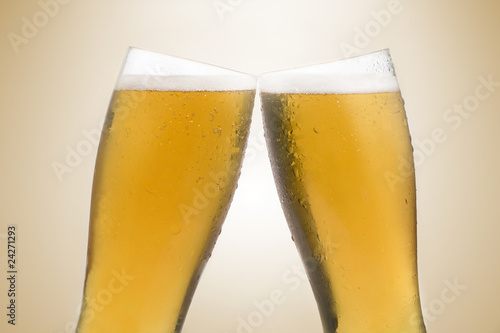 Pair of beer glasses making a toast. Beer splash Pair of beer glasses making a toast. Beer splash