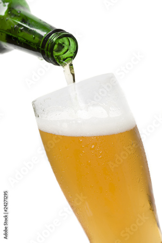 pouring beer in beer glass isolated on white background