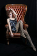 Beautiful model, photographed sitting on a big Chair