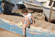 young girl sits on the boat