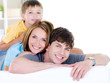 Happy smiling family of three people
