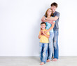 Family in embrace near the wall