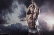 Young handsome muscular guy in a nature