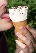 Girl licking tongue ice cream, cream in cup