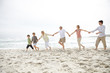 Sweet family playing on the sea shore - Outdoor