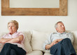 Senior woman and her husband looking away after an argument