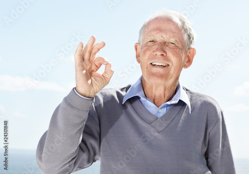 Photo: Happy old man showing okay sign - Outdoor Happy old man showing okay sign - Outdoor
