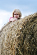 young woman and huge haystack