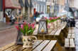 Cafe table with flowers and lantern. Focus on flowers