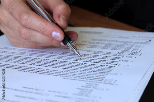 Photo: review and filling out legal contract review and filling out legal contract